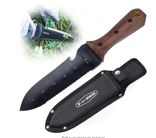 A hori hori gardening knife is displayed diagonally on a white background, along with its black fabric sheath. The knife has a black stainless steel blade with inch markings from 1 to 6 and a serrated edge on one side. The handle is brown wood with three visible rivets and a hole at the end. In the upper left corner, a circular inset image shows a hand holding the Perwin knife and cutting through green weeds in a garden setting